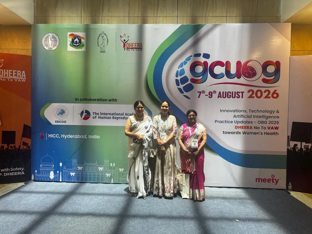 Dr. B.K.N. Sudha with colleagues at GCUOG conference backdrop